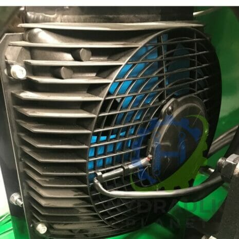 37 kW POWER UNIT-6 hydraulicplanet Close-up of a black cooling fan with protective grille and wiring, mounted on a green industrial machine fitted with P40 SERIES MONOBLOCK CONTROL VALVES.